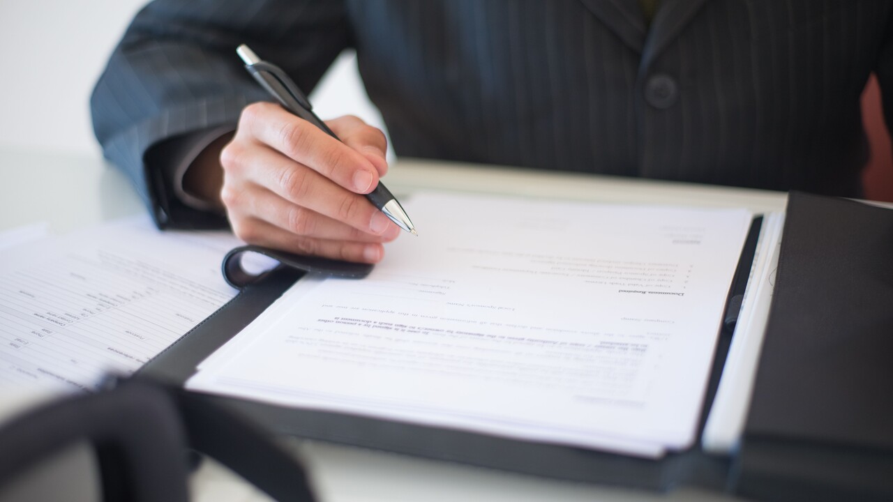 Thumbnail for Challenges of Implementing the EU AI Act for High-Risk AI Systems representing a person signing a contract.